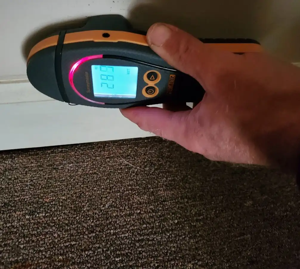 Moisture detection at baseboard during Storm Damage Restoration in Fleming Island